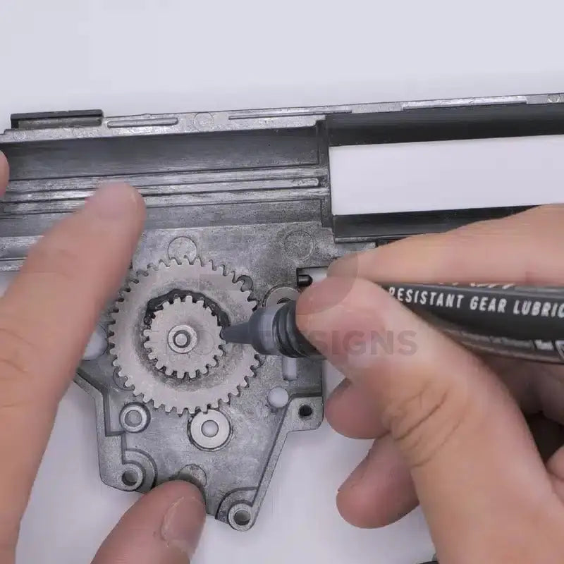 4uantum Heat Resistant Gear Lubricant applied with the pen tip to the gears inside an open airsoft AEG gearbox