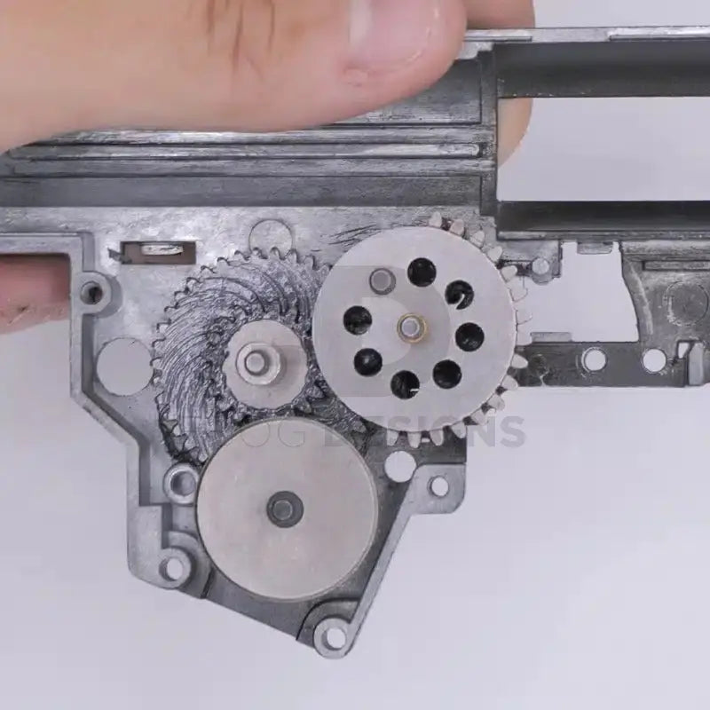 4uantum Heat Resistant Gear Lubricant coating the gear set of an open airsoft AEG gearbox
