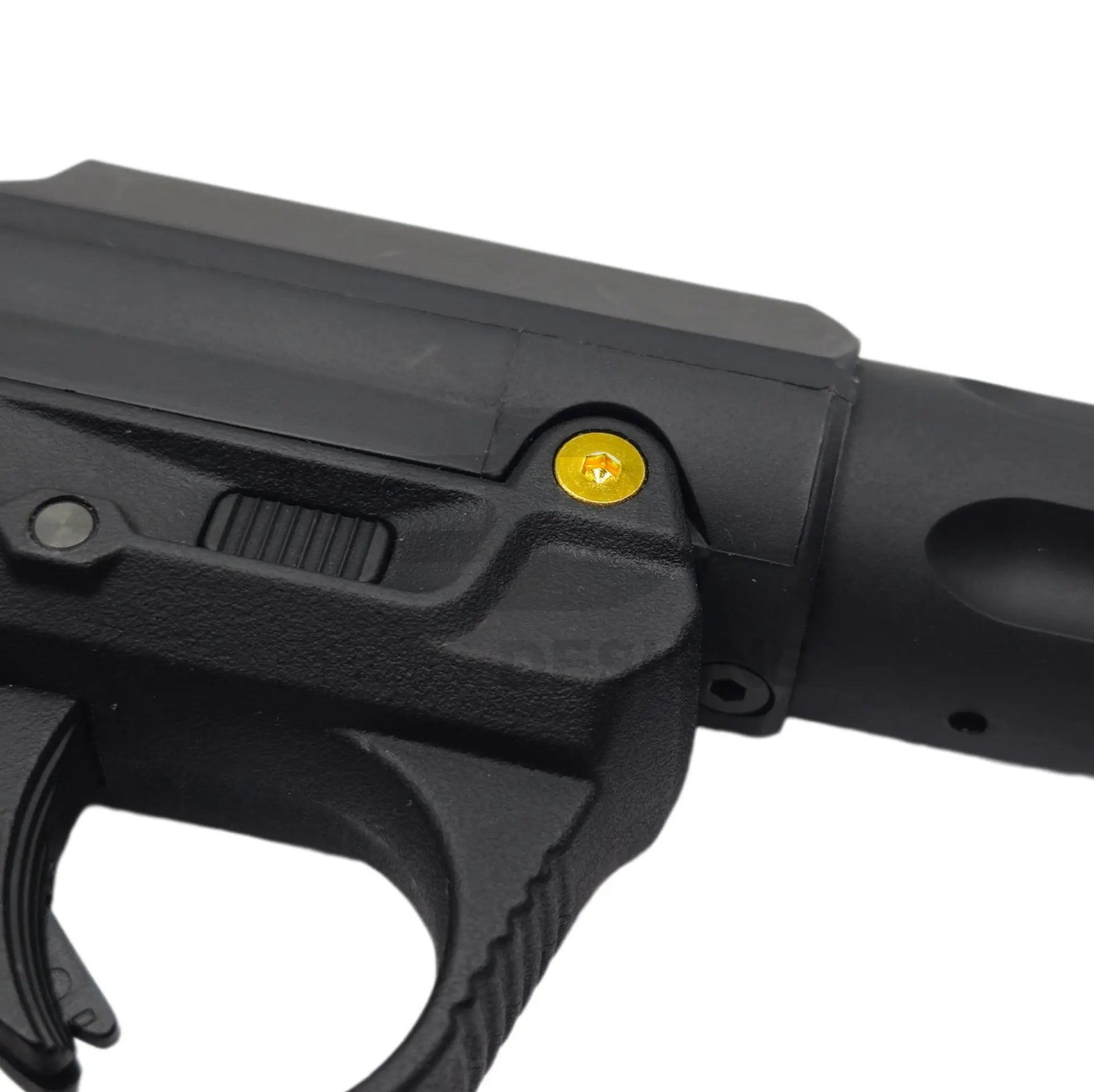 Ebog Designs AAP-01 XL trigger housing side screw fitted to the side of an AAP-01 trigger housing, gold