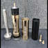 Sniper Mechanics SRS W.A.S.P weight adjustable piston kit laid out: stainless spring guide, gold piston body, weight sleeves and airbrake fittings