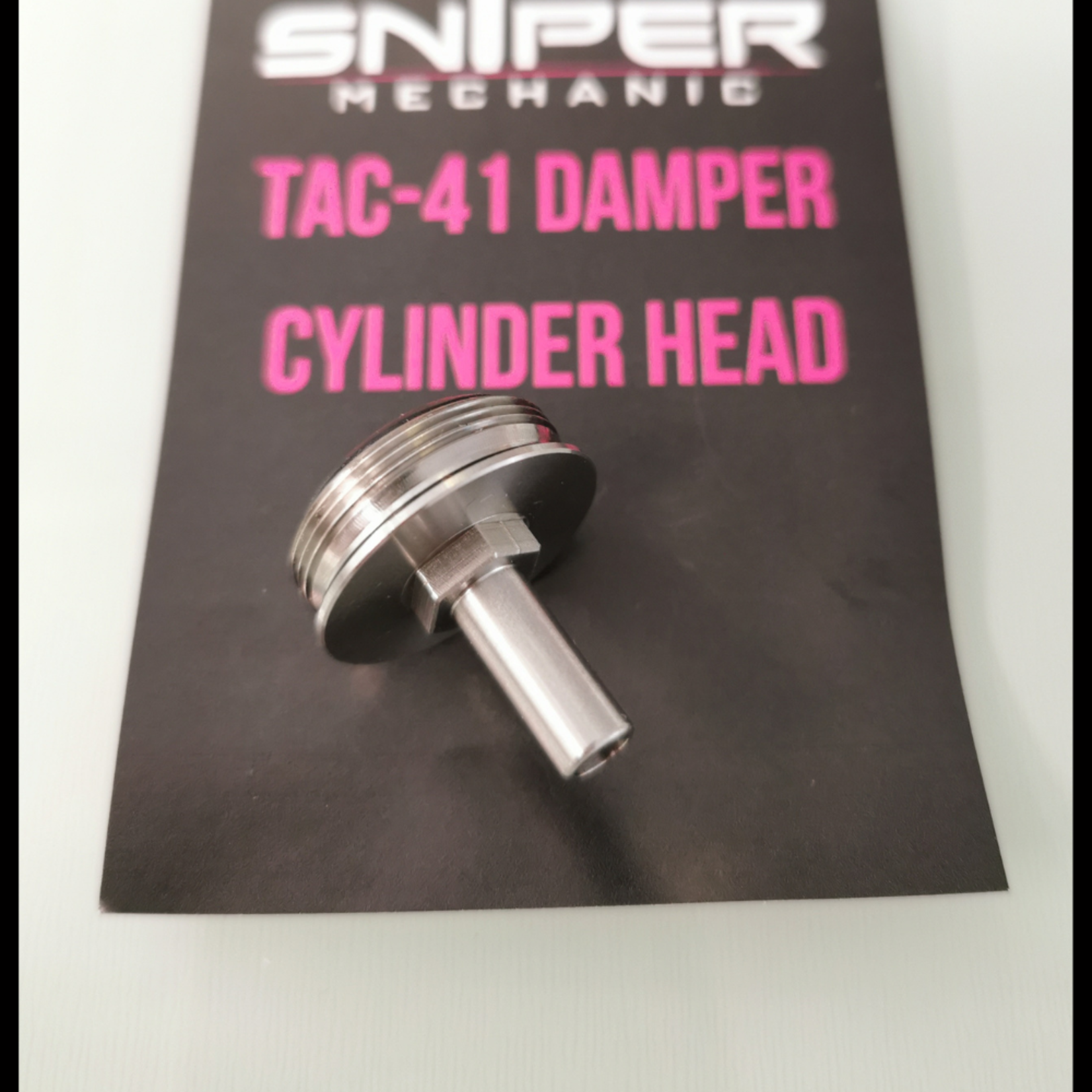 Sniper Mechanics TAC-41 damper cylinder head, GBB version, a stainless head with dual bore nozzle on its branded card